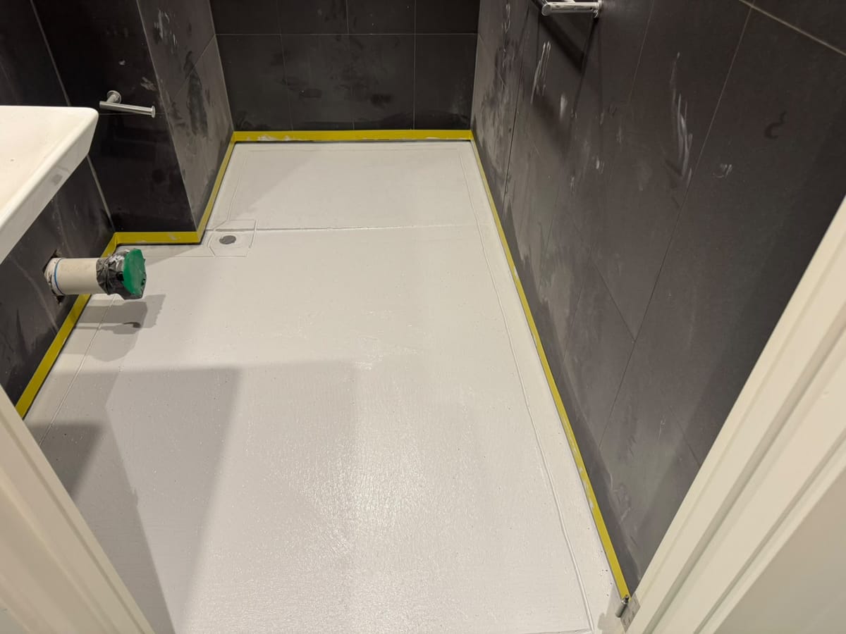 Bathroom floor coated with grey waterproofing membrane prior to tiling — Melbourne