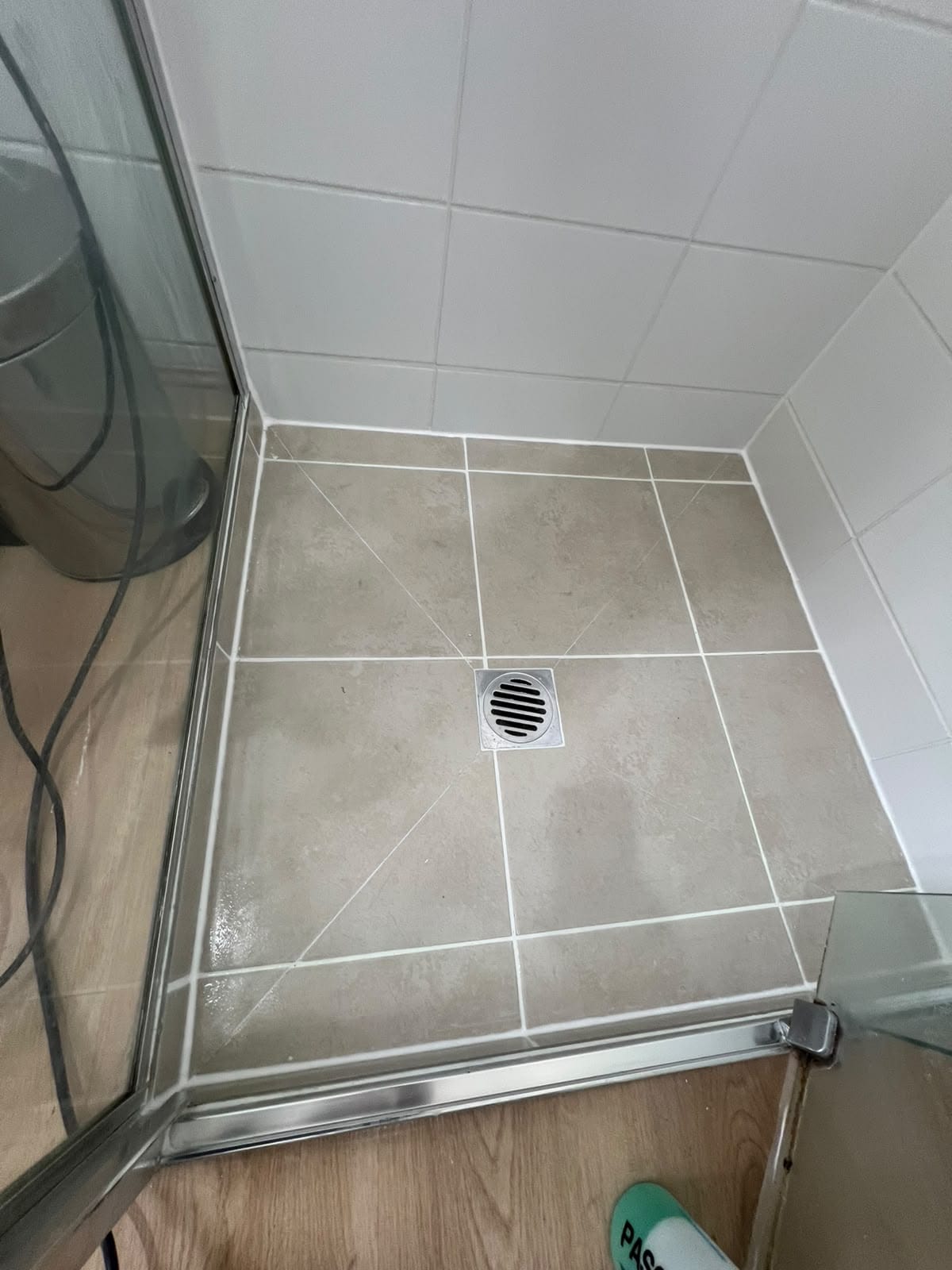 Same shower floor restored with clean white grout lines and fresh perimeter silicone — Melbourne