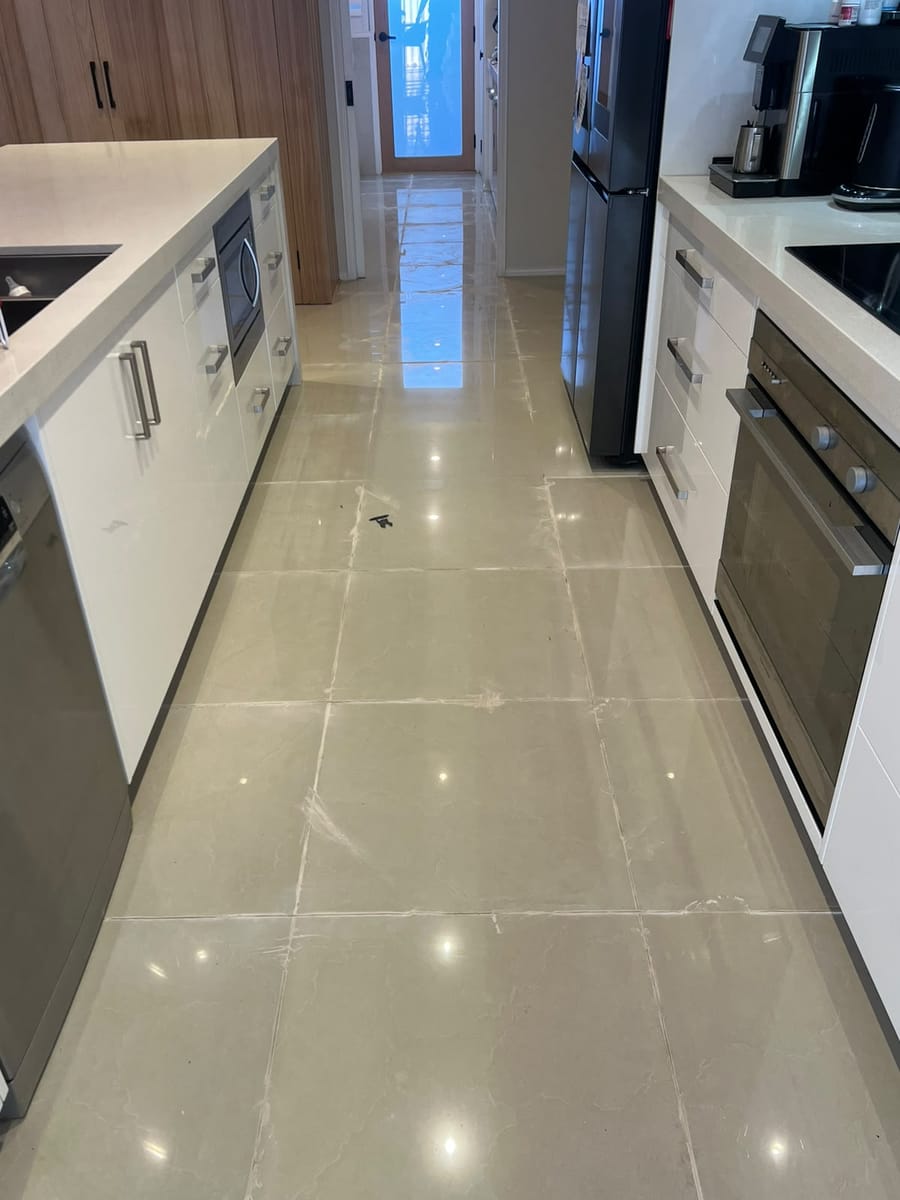 Tradesperson carefully replacing an individual cracked tile in a residential bathroom