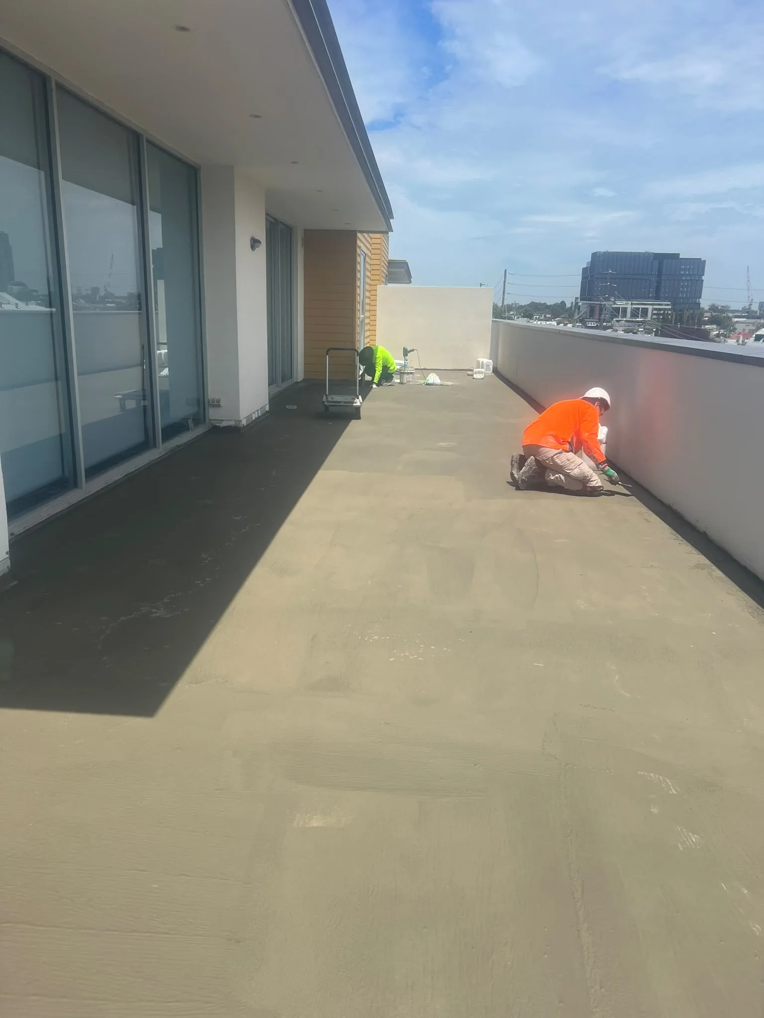 External balcony deck substrate being coated with liquid waterproofing membrane — Melbourne