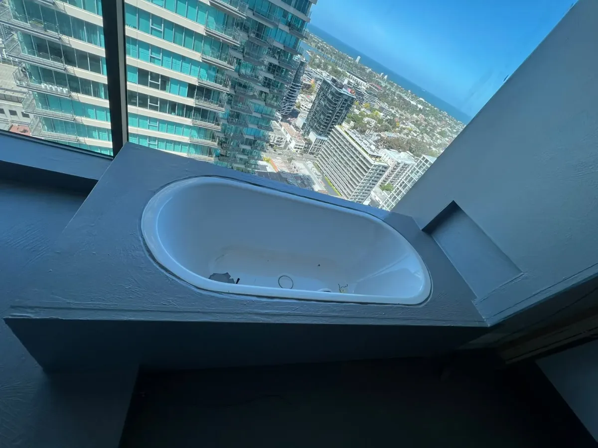 Inset bathtub hob coated with grey waterproofing membrane prior to stone installation — Melbourne