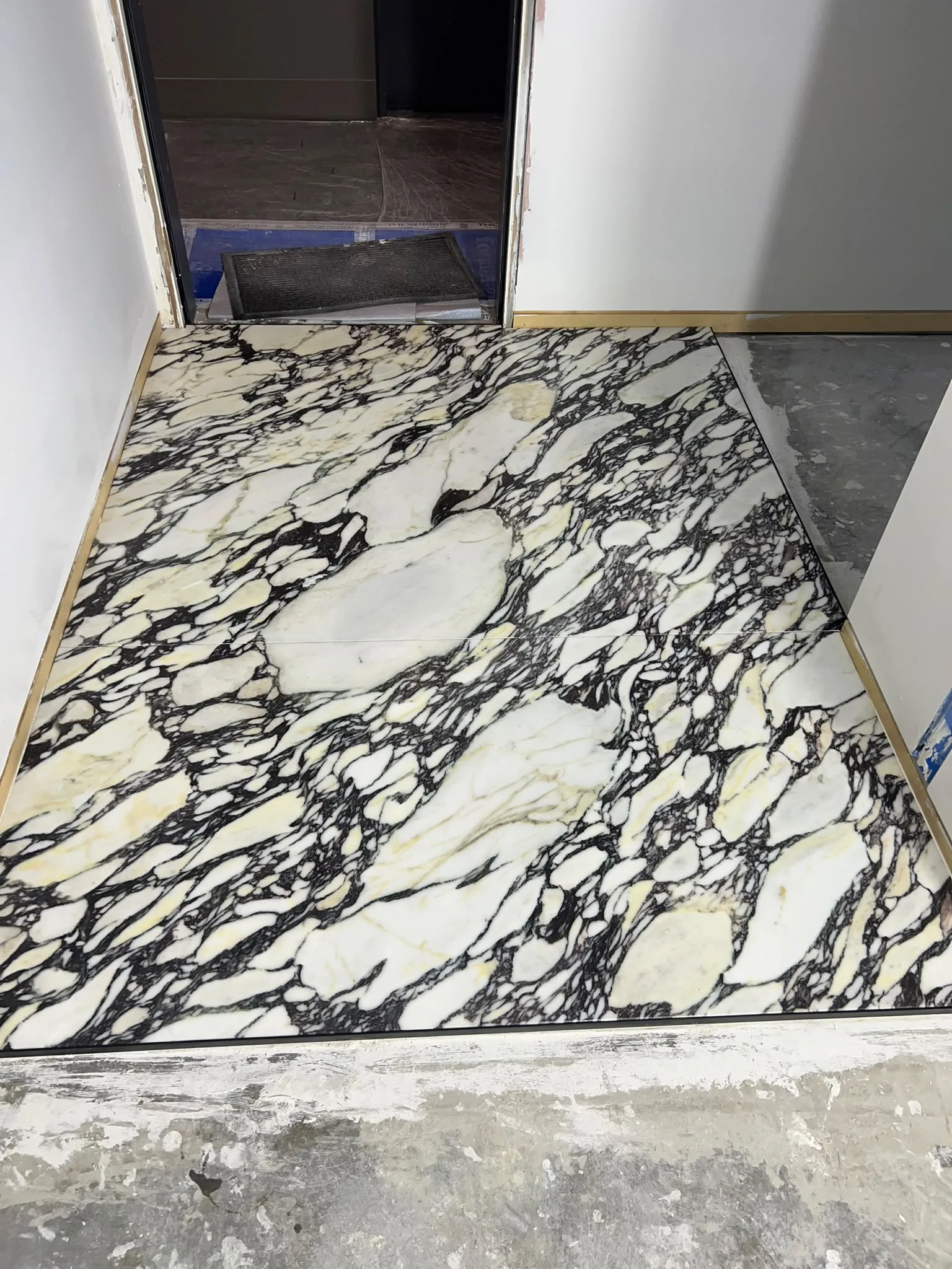 Modern ensuite bathroom restoration featuring clean floor tiles, vanity resealing and sanitary finishes