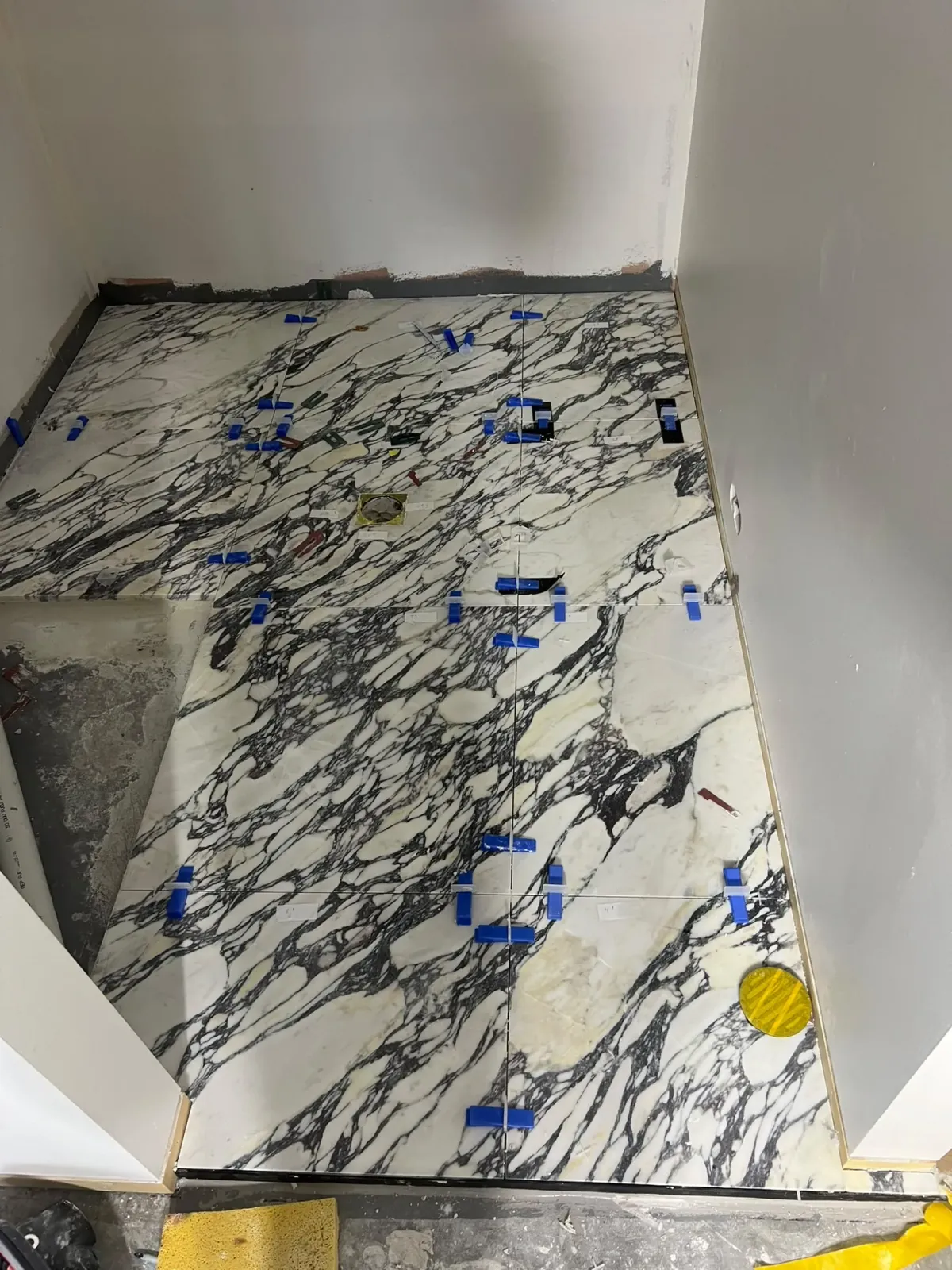 Calacatta Viola marble floor tiles laid with mechanical levelling clips — Melbourne