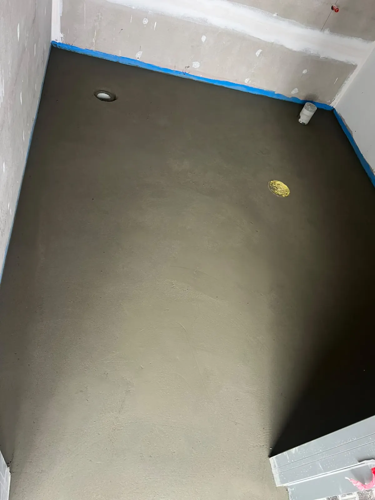 Engineered sand and cement mortar screed bed laid with drainage falls to floor waste — Melbourne