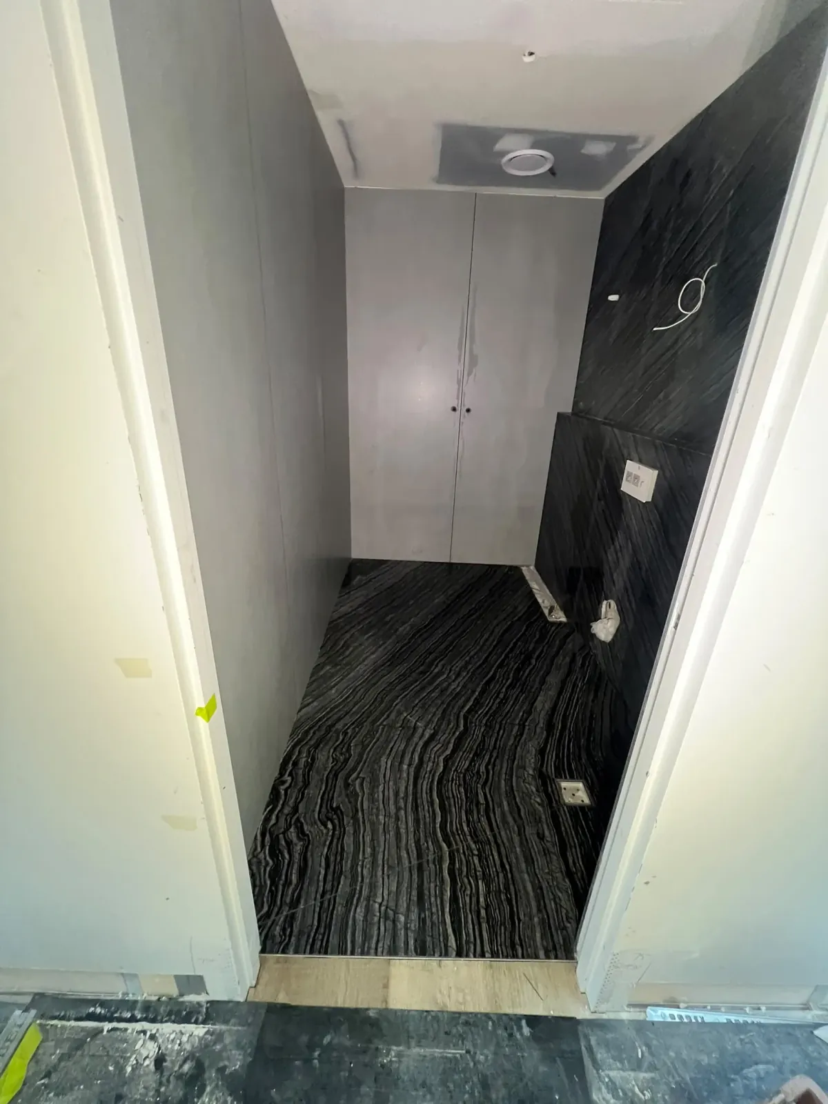 Linear-veined Striato black marble bathroom floor and wall tiling with smart drain — Melbourne