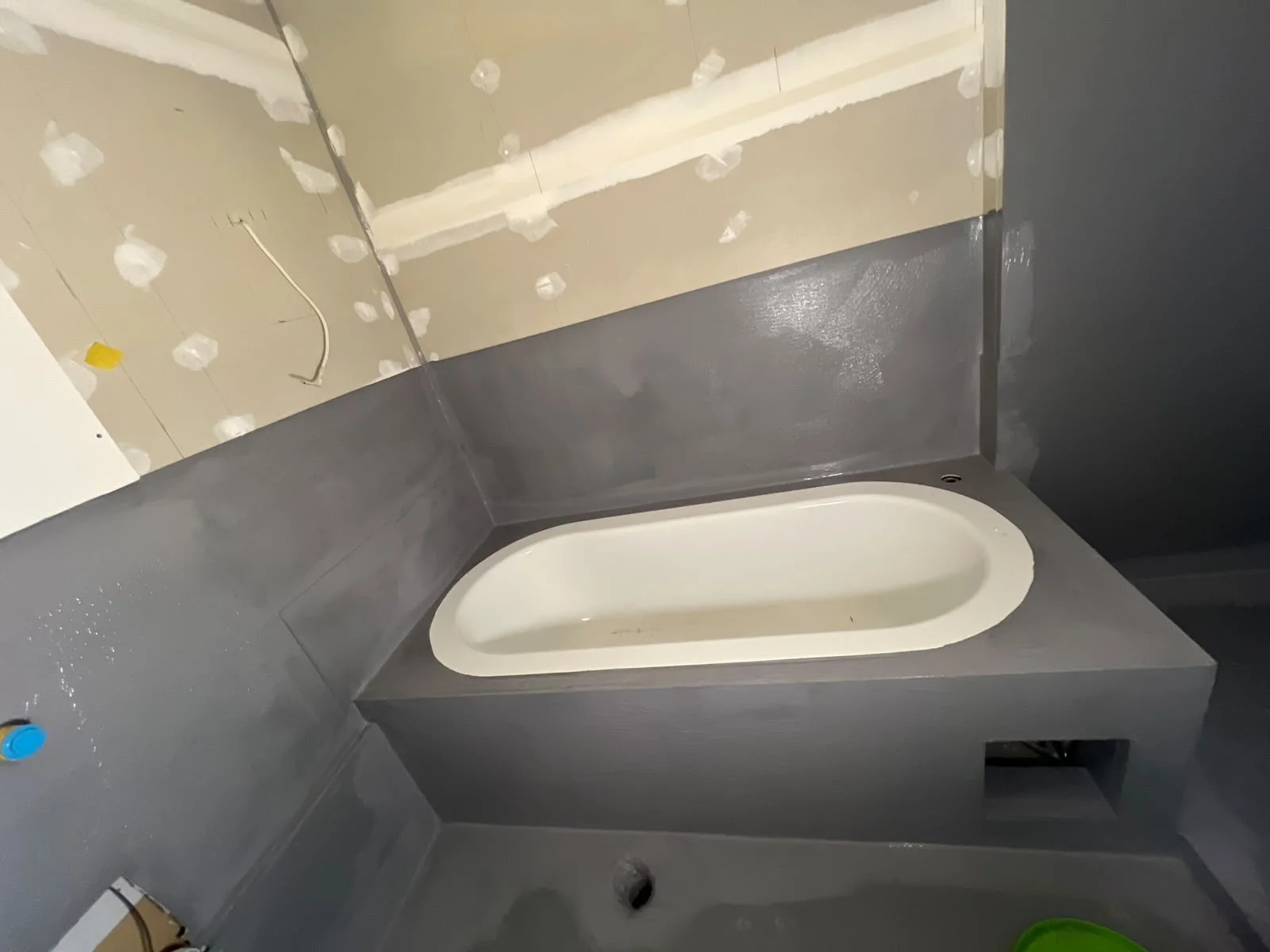 Waterproofing membrane flashing applied to bathtub hob and floor junction — Melbourne