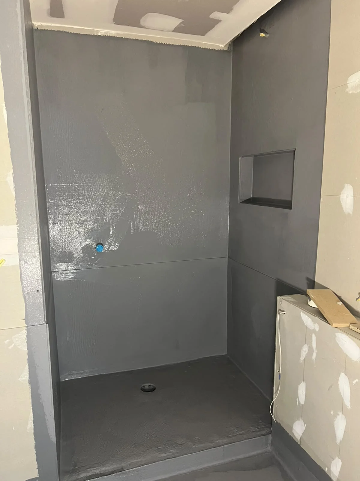 Waterproofing membrane applied across shower recess walls, recessed niche, and floor — Melbourne